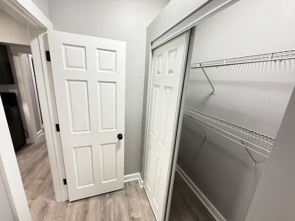a view of a hallway with wooden floor and staircase