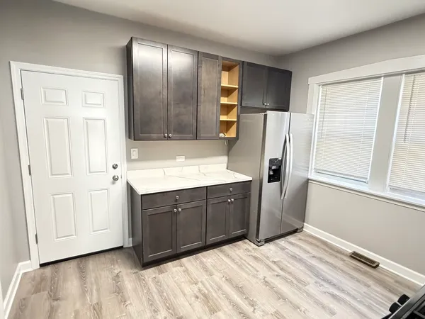a kitchen with stainless steel appliances granite countertop a refrigerator and a sink