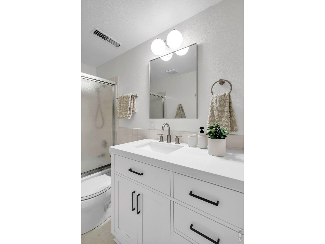 3545 Clover Circle Boulder, CO 80304 - Photo 32 of 36 a bathroom with a sink a toilet a mirror and vanity