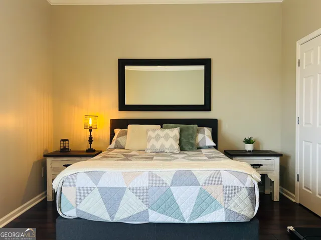a bathroom with a granite countertop sink toilet a mirror a vanity and shower