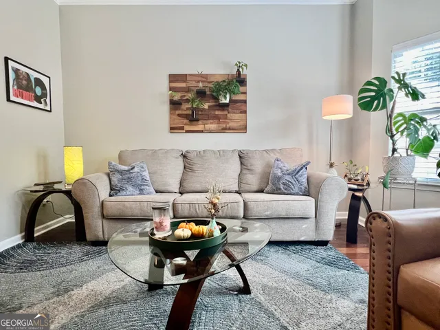 a living room with furniture and a potted plant