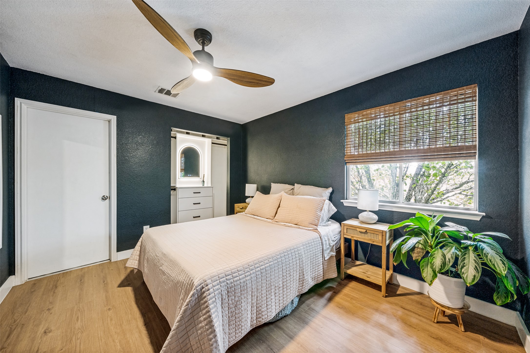 9205 Rowlands Sayle Road Austin, TX 78744 - Photo 14 of 25 Hardwood floors and a sophisticated ceiling fan complete this comfortable bedroom.
