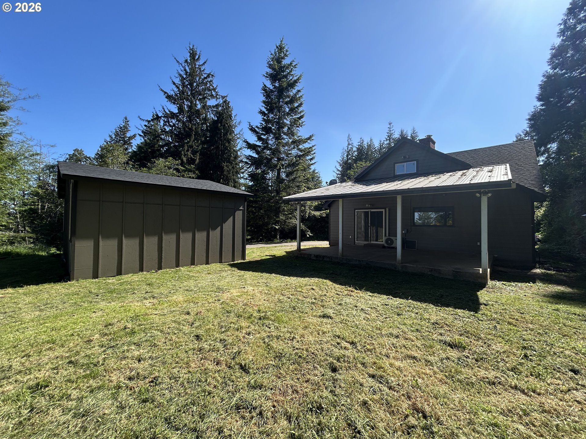 62356 Olive Barber Road Coos Bay, OR 97420 - Photo 3 of 34 a front view of house with yard and trees in the background