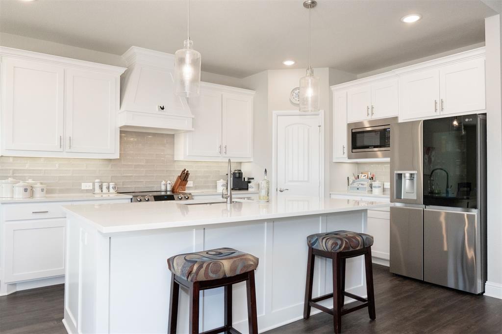 849 County Road 4764 Boyd, TX 76023 - Photo 11 of 40 a kitchen with stainless steel appliances a sink a stove a refrigerator cabinets and dining table