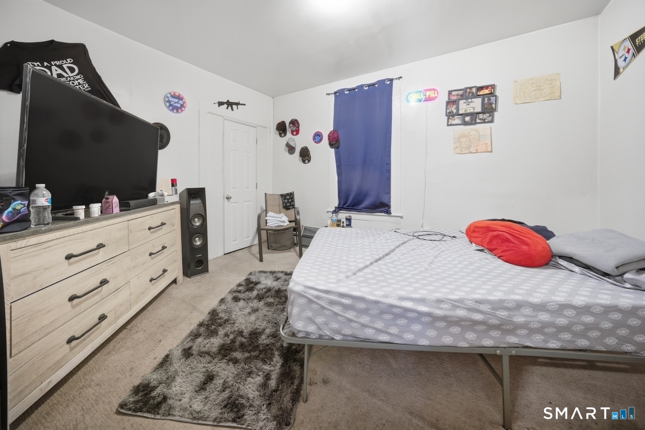12 Webster Street Vernon, CT 06066 - Photo 17 of 33 a bedroom with a bed and a flat screen tv