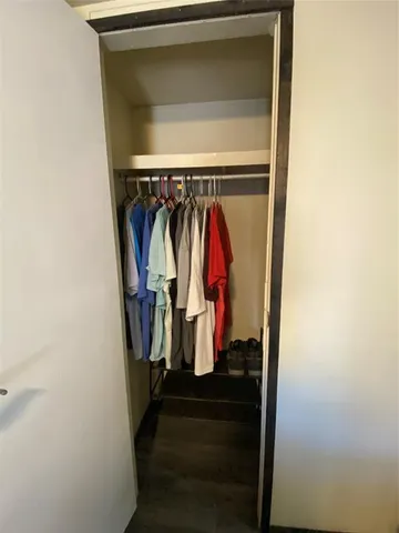 a view of walk in closet with clothes