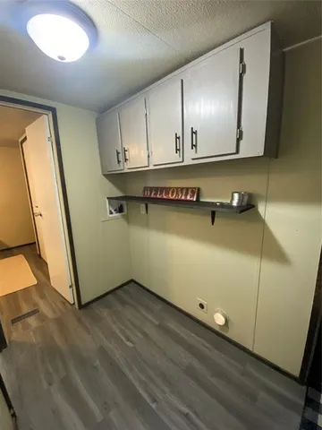 a room with a wooden floor and brick walls