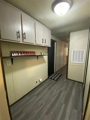 a kitchen with granite countertop a refrigerator a sink and dishwasher