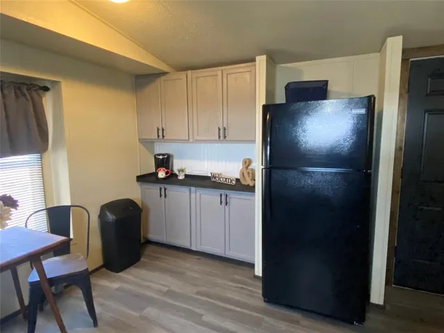 a kitchen with a refrigerator and cabinets
