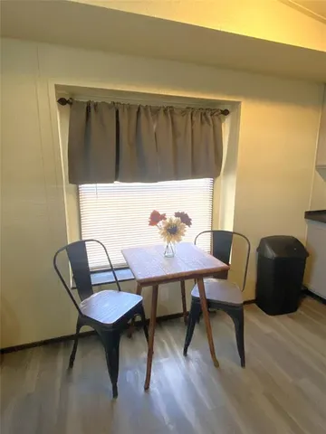 a view of a chairs and table in a balcony