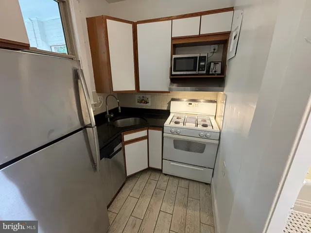 a kitchen with a stove and a microwave