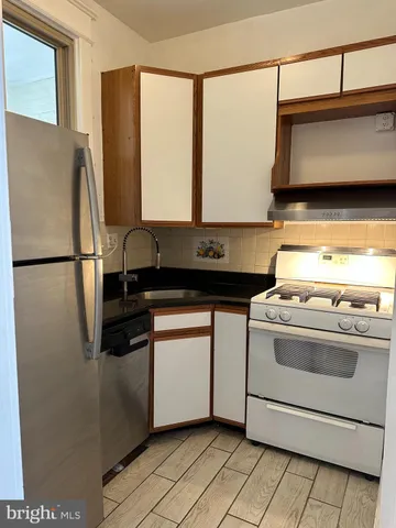 a kitchen with stainless steel appliances granite countertop a stove a microwave and a refrigerator