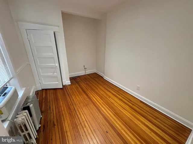 a view of a room with wooden floor and staircase