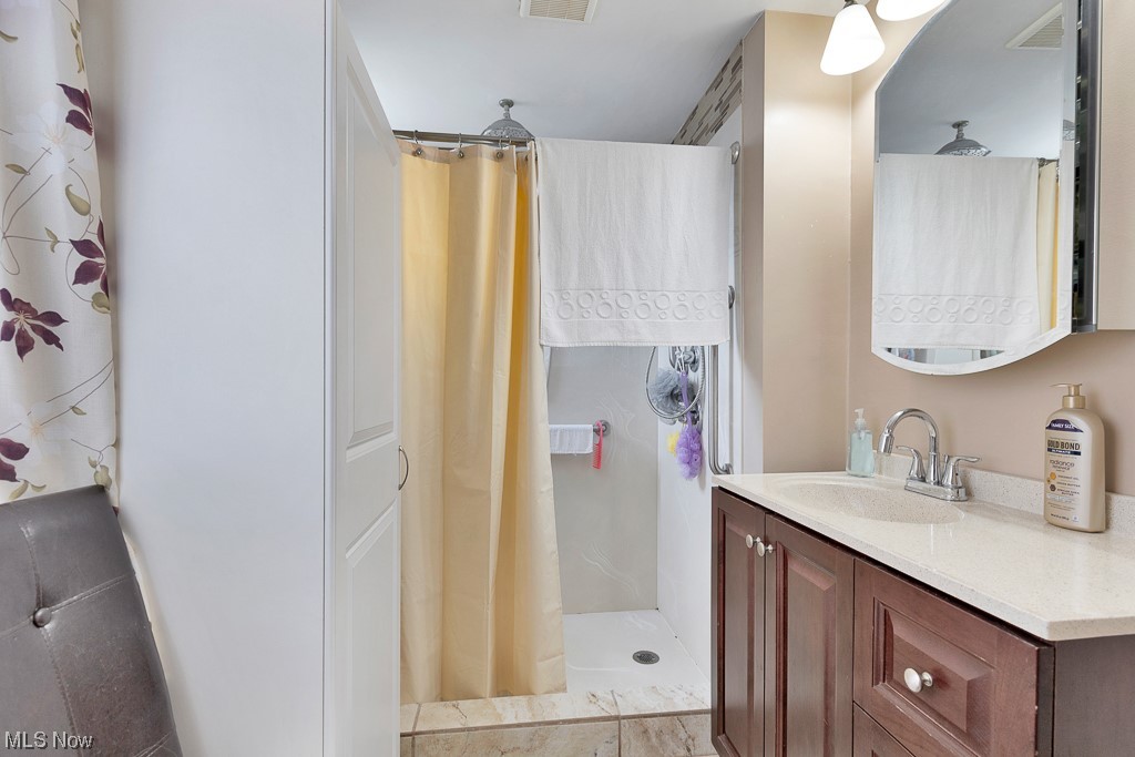 8007 Snow Road Parma, OH 44129 - Photo 20 of 25 Bathroom with vanity and walk in shower