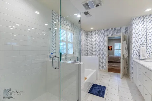 a bathroom with a shower and a sink