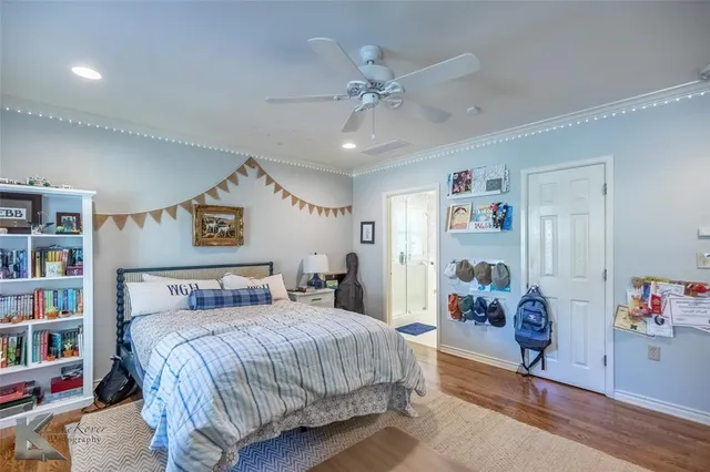 a bedroom with a bed and a book shelf