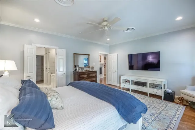 a bedroom with a bed and a flat screen television