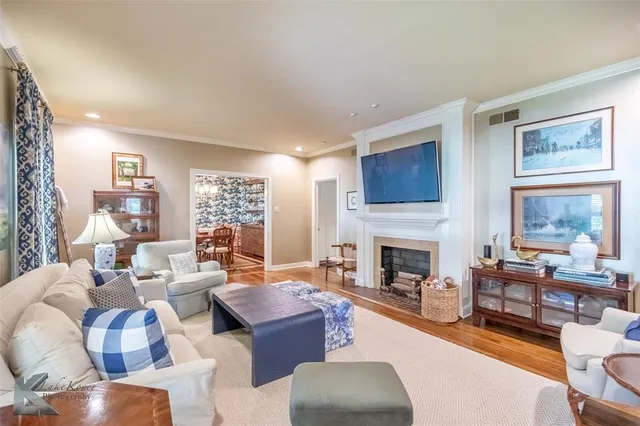 a living room with fireplace furniture and a large window