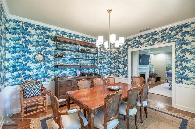 a view of a dining room with furniture wooden floor and chandelier