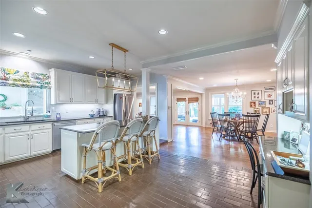 a kitchen with counter space dining table and chairs