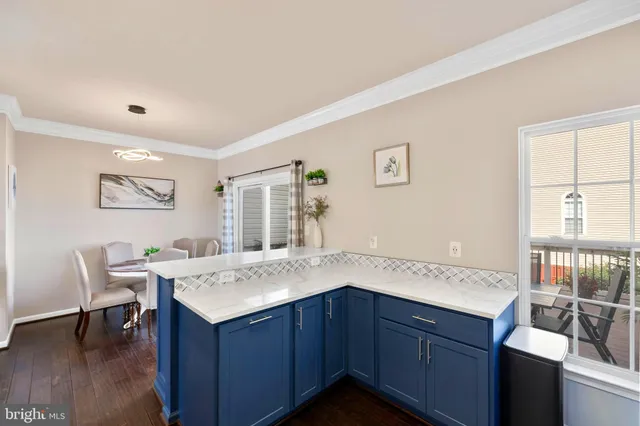 a open kitchen with a sink cabinets and wooden floor