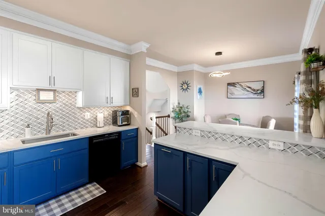 a kitchen with granite countertop a sink and cabinets