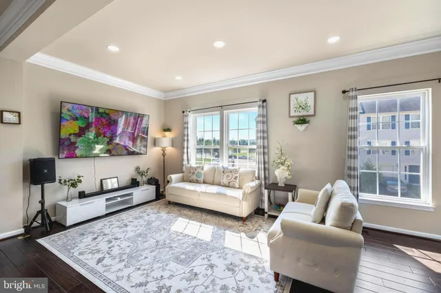 a living room with furniture flat screen tv and a couch
