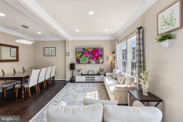 a living room with furniture a rug and a flat screen tv