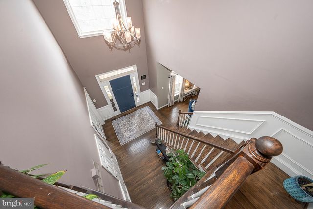 a dining room with furniture a chandelier and window