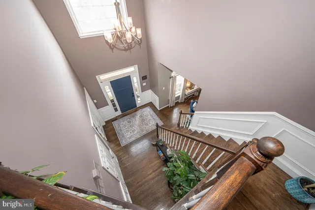 a dining room with furniture a chandelier and window