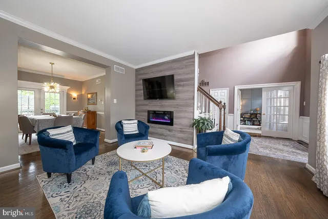 a dining room with furniture a chandelier and wooden floor