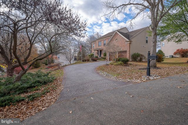 a front view of house with yard and trees around