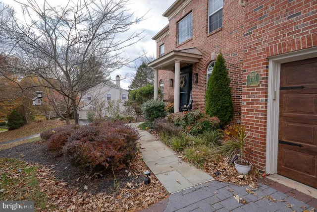 a view of an entryway with wooden floor and a livingroom