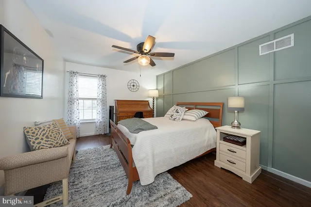 a living room with a couch and a lamp