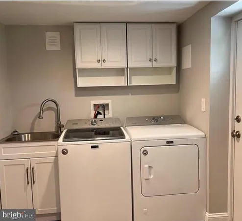 a view of a kitchen with sink and washer