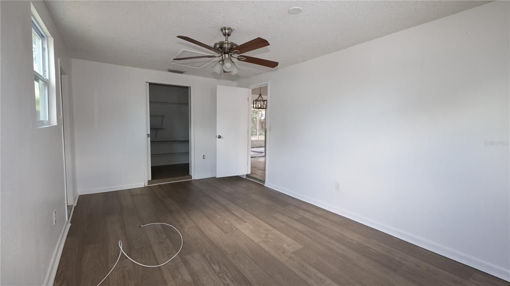4300 Las Vegas Drive New Port Richey, FL 34653 - Photo 5 of 14 an empty room with wooden floor closet and windows