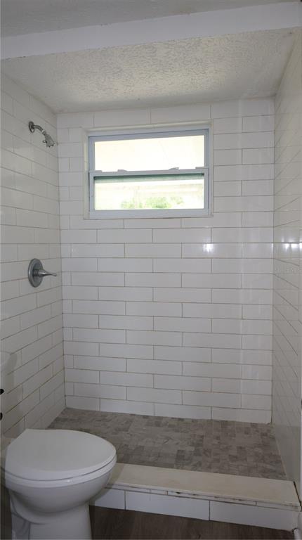 4300 Las Vegas Drive New Port Richey, FL 34653 - Photo 7 of 14 a bathroom with a toilet and a shower