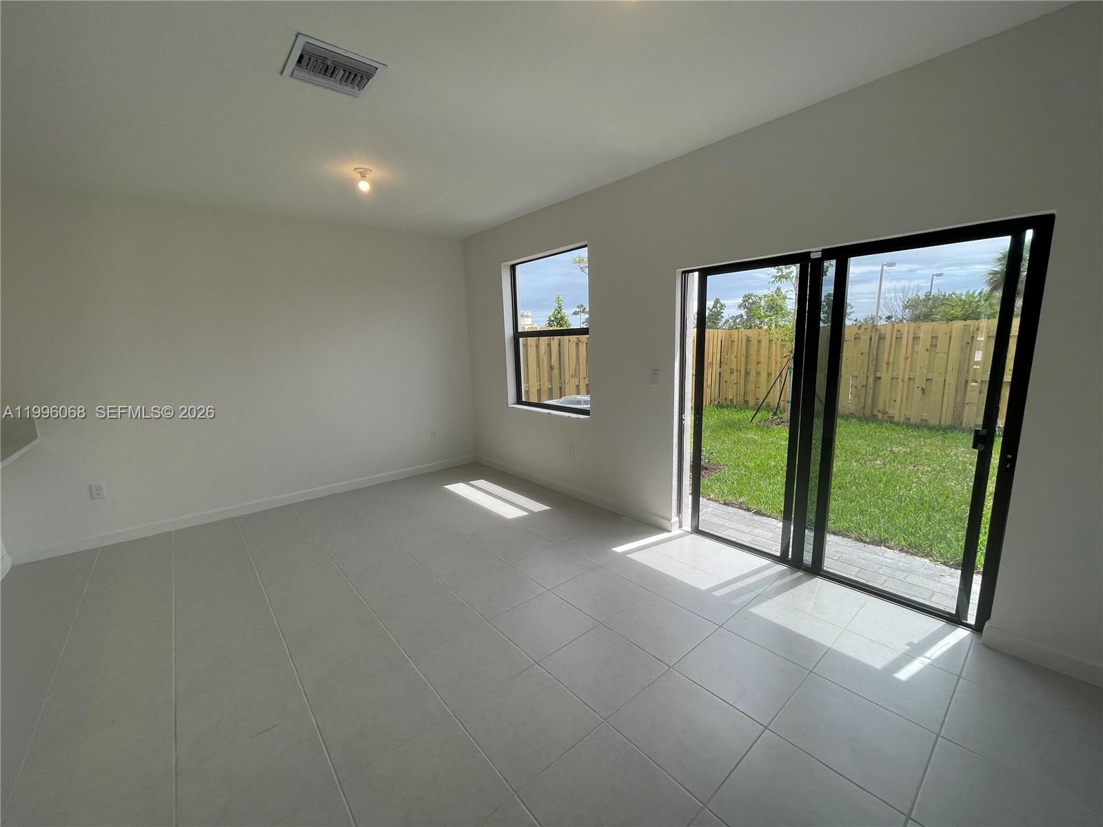 13262 Southwest 287th Terrace Homestead, FL 33033 - Photo 28 of 33 an empty room with sliding door and windows
