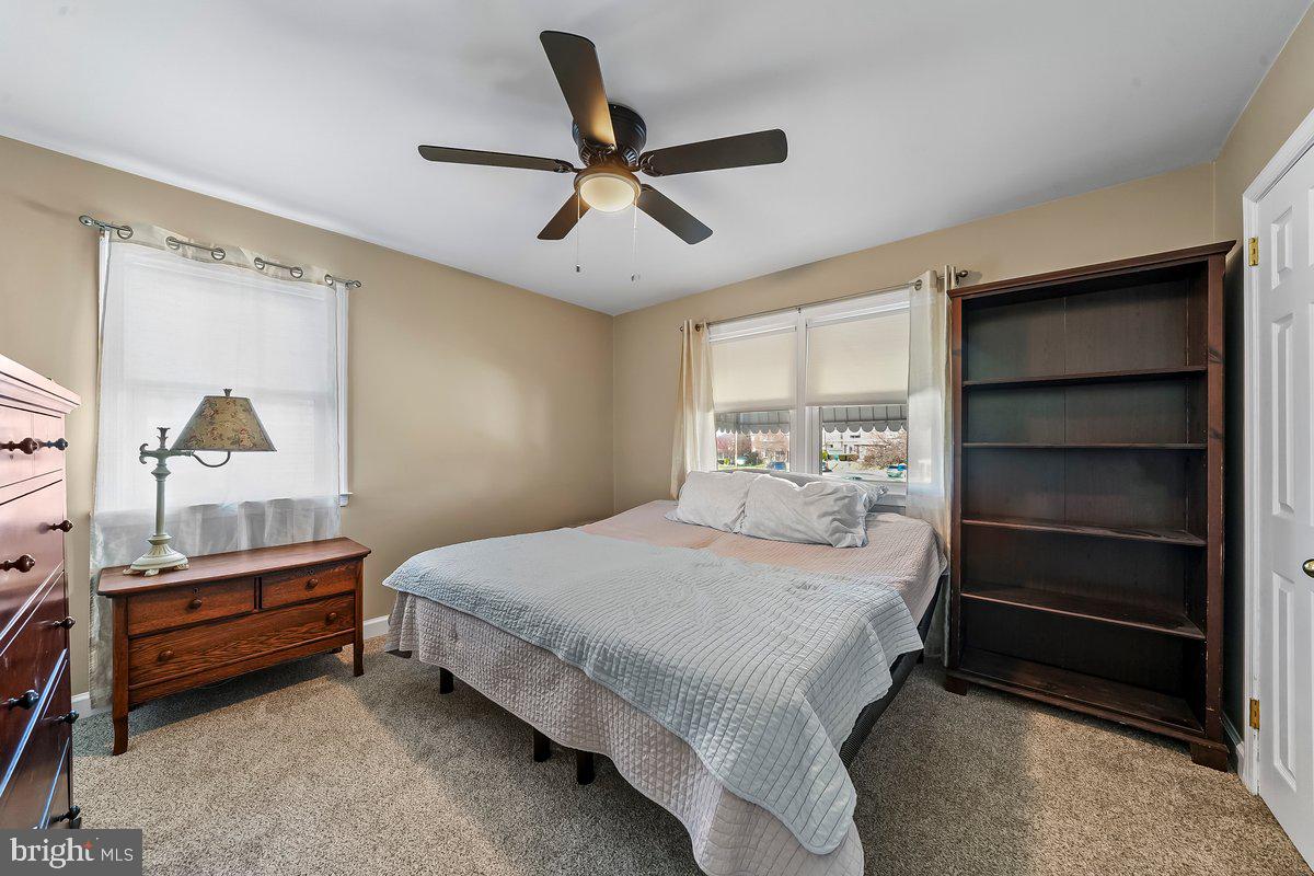 114 Lakeview Drive Ridley Park, PA 19078 - Photo 15 of 37 a bedroom with a bed and a chandelier