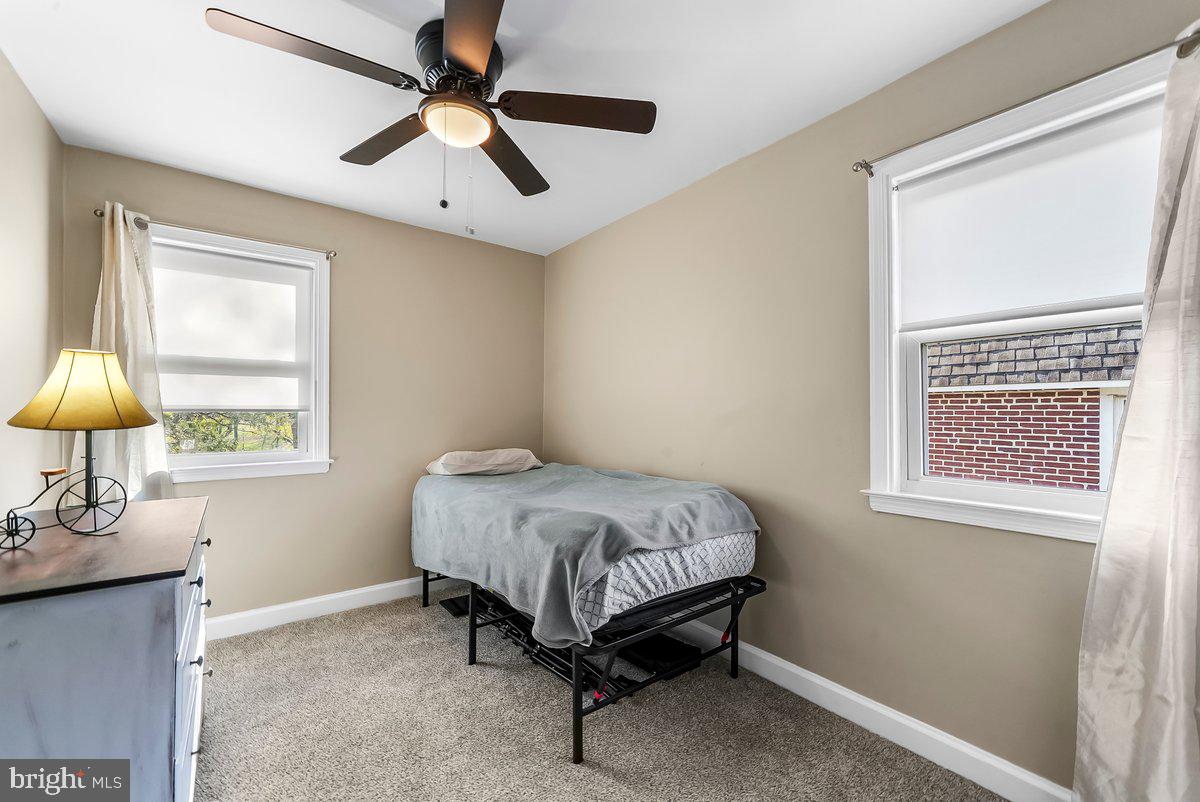 114 Lakeview Drive Ridley Park, PA 19078 - Photo 17 of 37 a bedroom with a bed and a chandelier