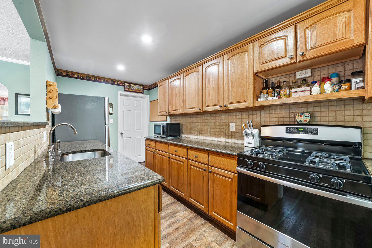 114 Lakeview Drive Ridley Park, PA 19078 - Photo 8 of 37 a kitchen with stainless steel appliances granite countertop a sink stove and cabinets