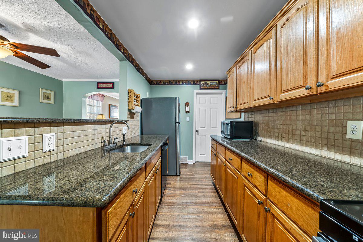114 Lakeview Drive Ridley Park, PA 19078 - Photo 10 of 37 a kitchen with stainless steel appliances granite countertop a sink and stove