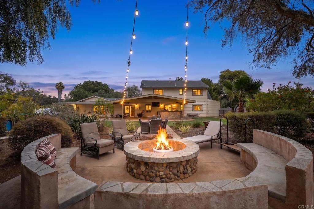 2430 Geyer Lane Alpine, CA 91901 - Photo 36 of 60 a view of a swimming pool with lawn chairs under an umbrella