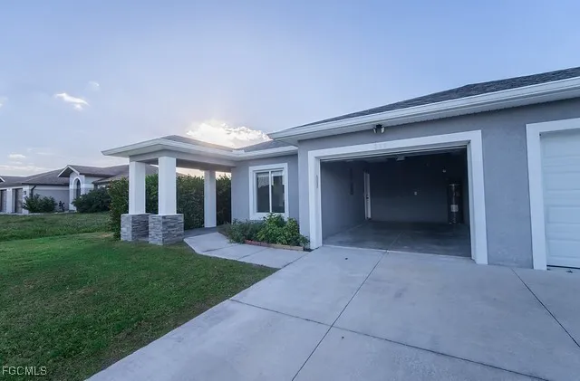 a view of a house with a yard and porch