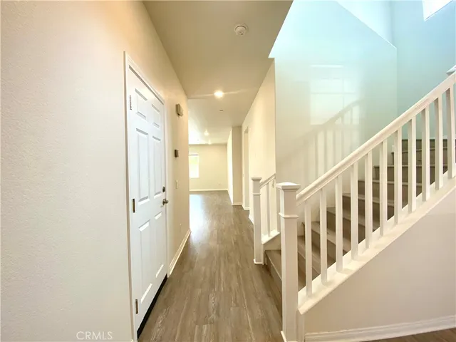 a view of a hallway with wooden floor