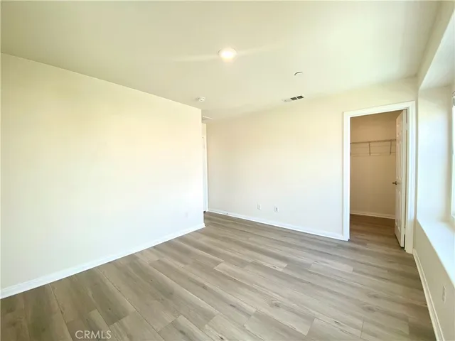 a bathroom with a granite countertop toilet a sink and a mirror