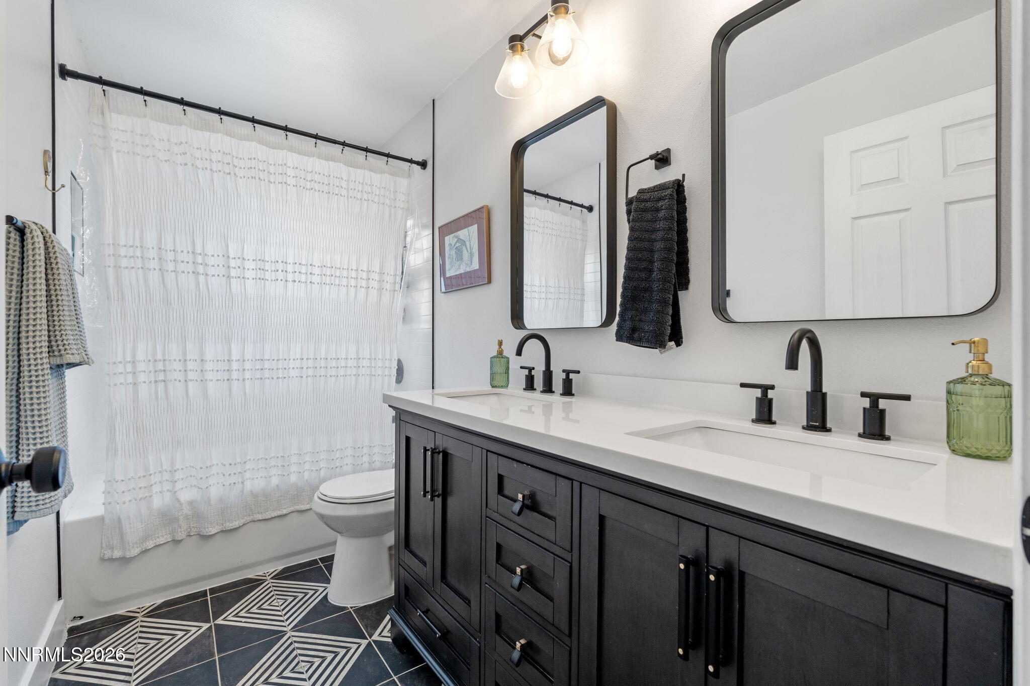 1530 Elmcrest Drive Reno, NV 89503 - Photo 21 of 36 a bathroom with a double vanity sink toilet mirror and shower