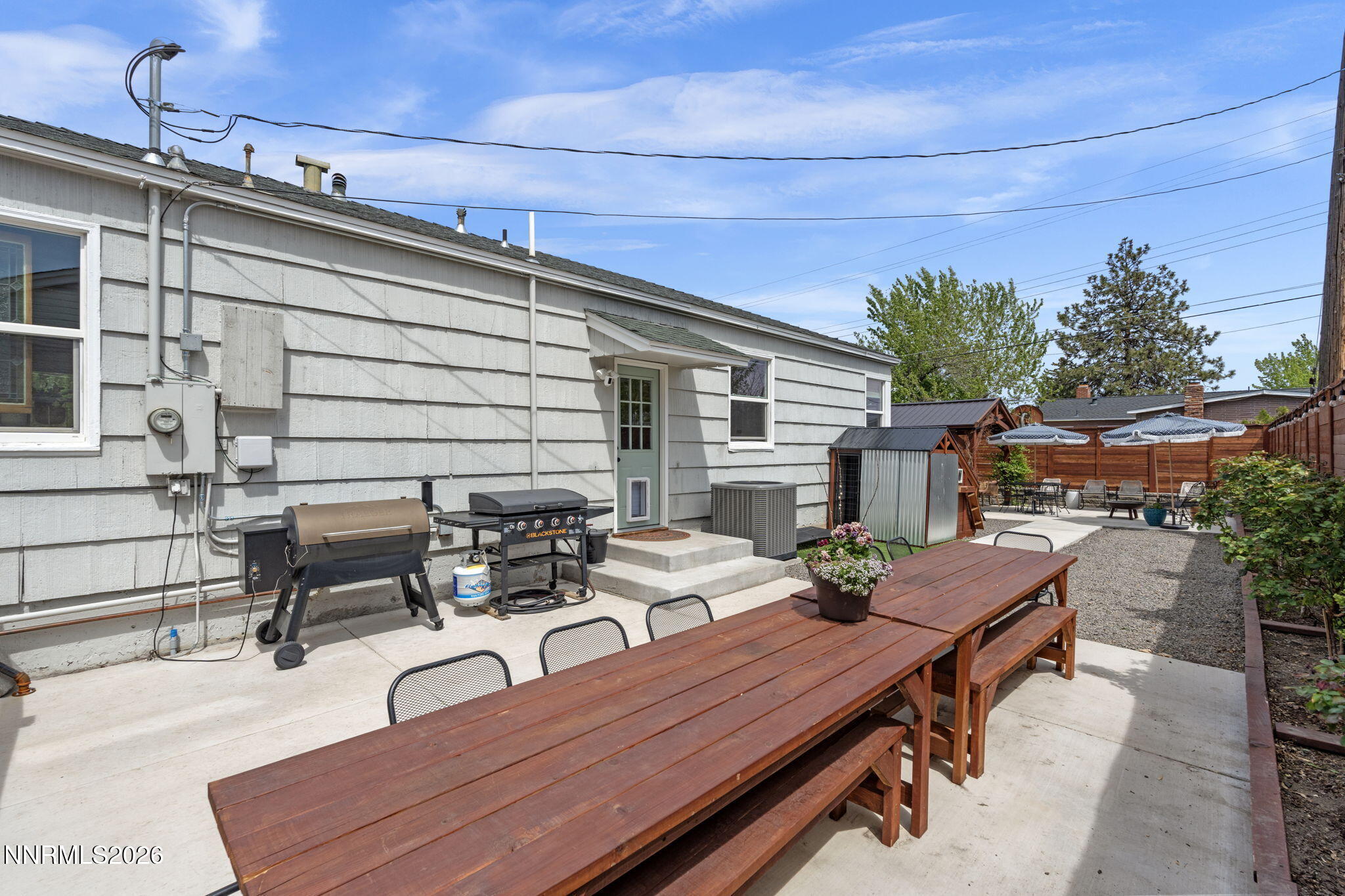 1530 Elmcrest Drive Reno, NV 89503 - Photo 30 of 36 a roof deck with a table and chairs and potted plants