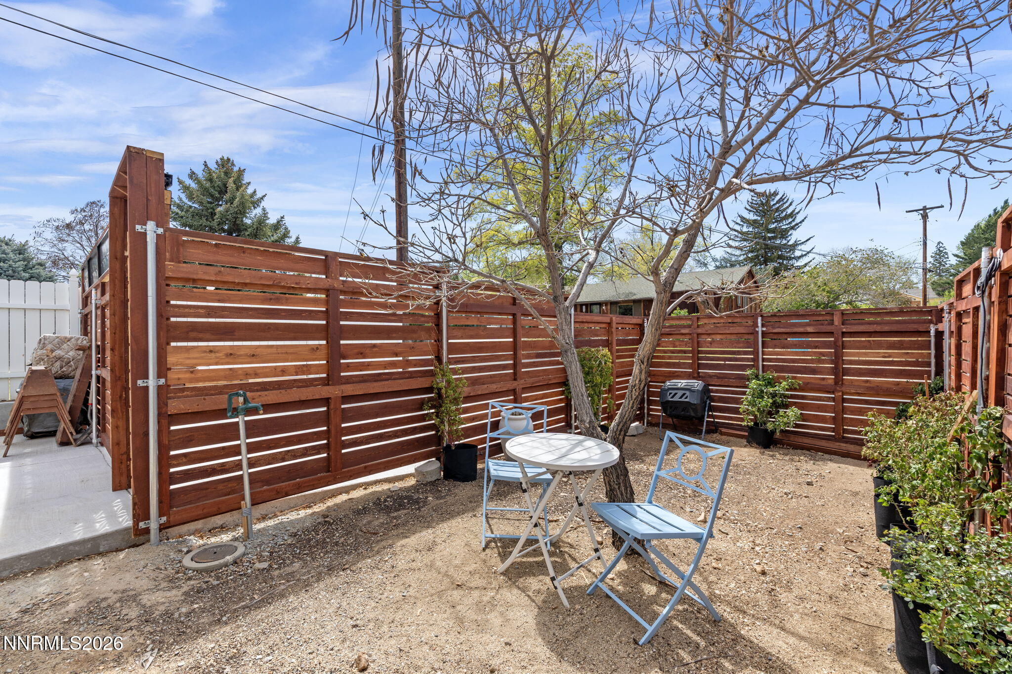 1530 Elmcrest Drive Reno, NV 89503 - Photo 36 of 36 a view of a patio with a table and chairs and wooden fence