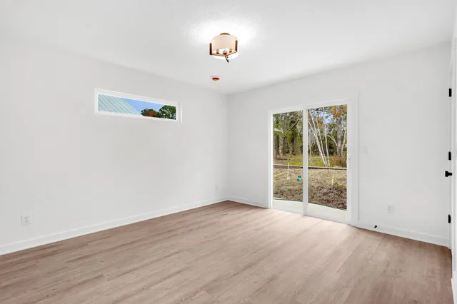 a kitchen with stainless steel appliances a white stove top oven cabinets and a wooden floor